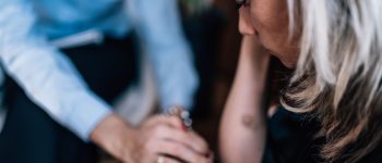 Mental Health - Psychotherapist holding patient’s hand, providing support during cognitive behavioral therapy session